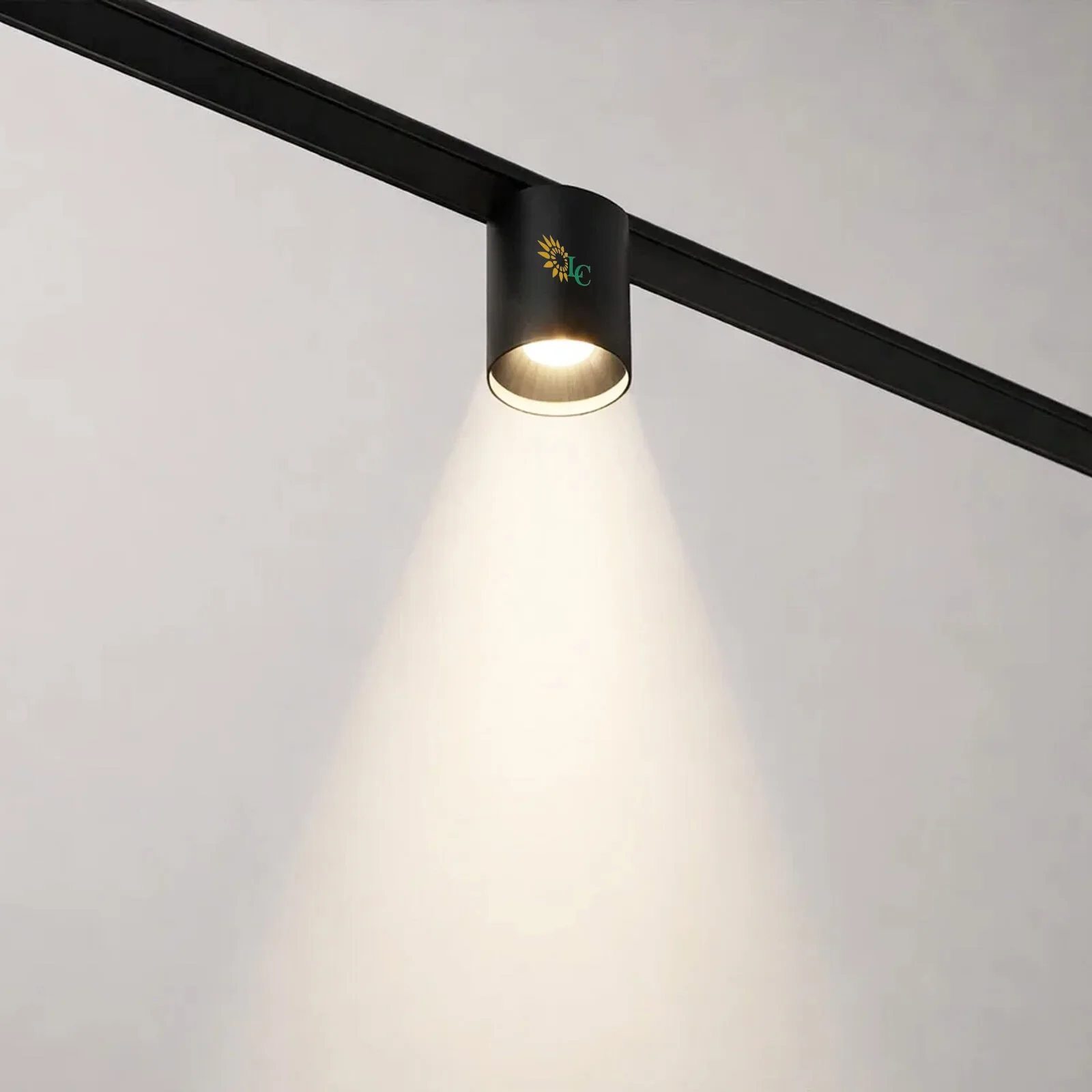 Adjustable black track light illuminating a white wall, modern lighting fixture for stylish interior.