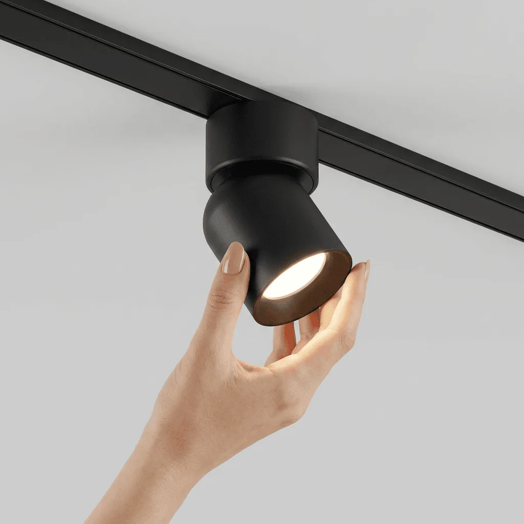 LED track lighting fixture being installed on a ceiling, modern interior lighting solution.