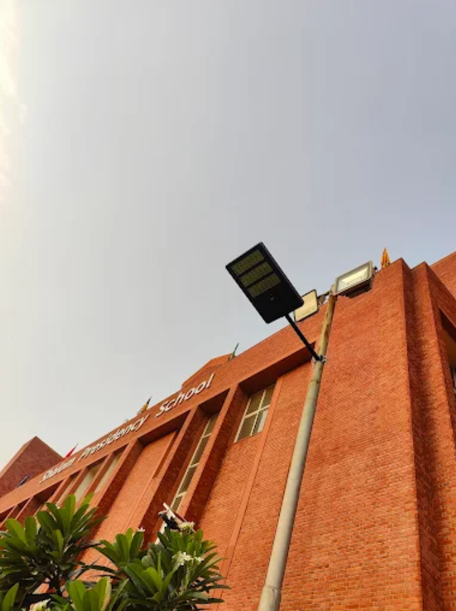 Solar street light installed outside residential house gate providing bright driveway lighting at night